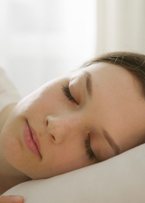 Close-up of a woman peacefully sleeping, showcasing serene relaxation and tranquility.